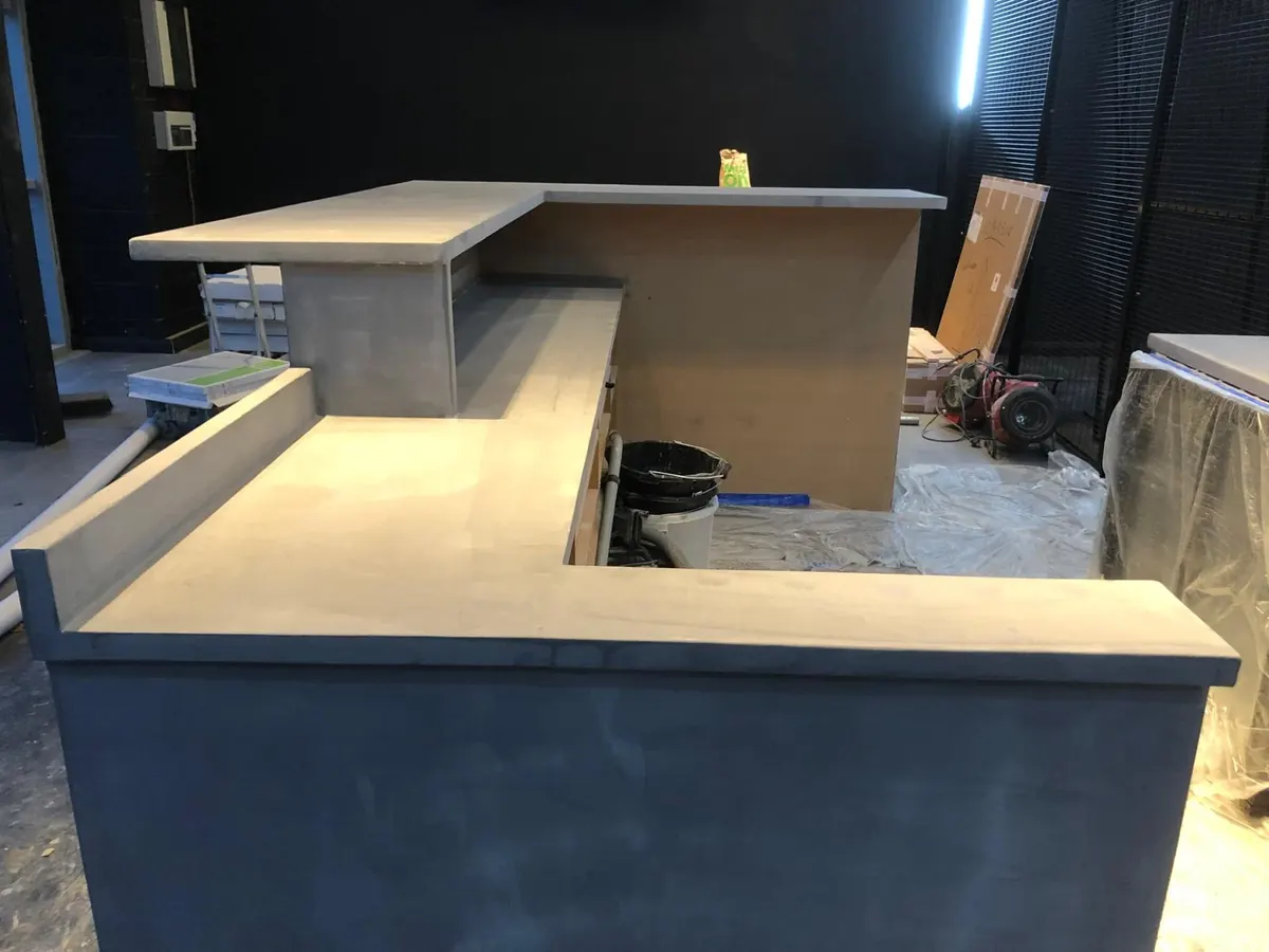 Stepped microcement worktops and upstand on a commercial reception counter