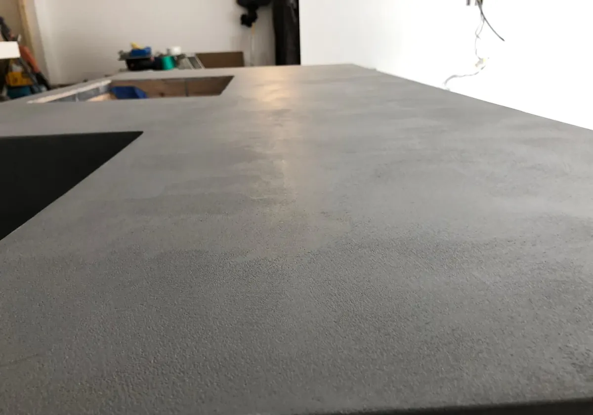 Close-up of the hand-trowelled texture on a grey microcement worktop